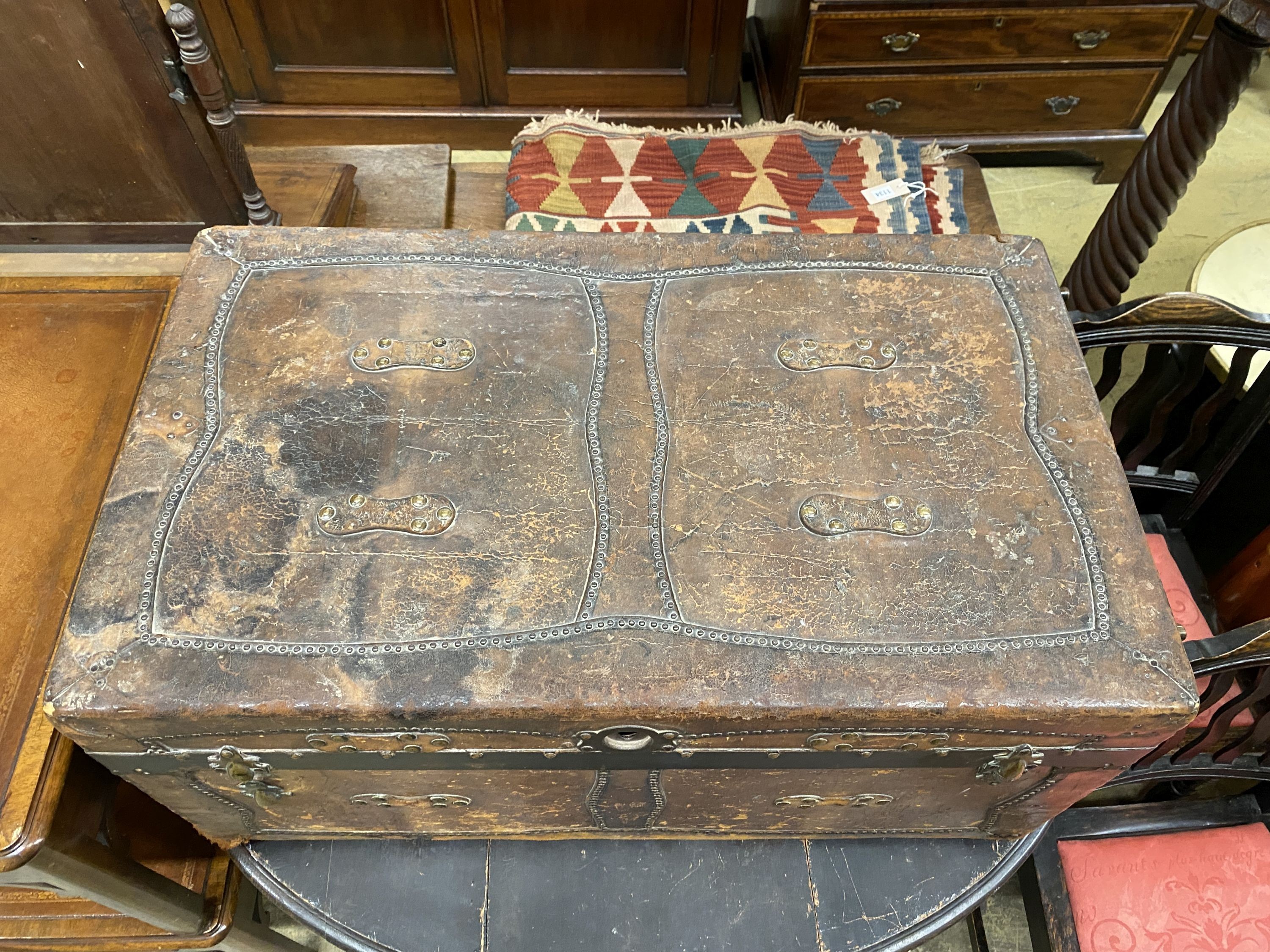 A 19th century studded brown leather covered trunk, length 87cm, depth 51cm, height 41cm